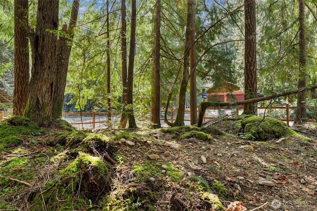 view of yard with a view of trees
