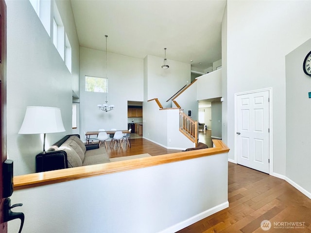 18126 SE 246th St, Covington, WA 98042 - interior space with a chandelier, wood finished floors, a high ceiling, and baseboards