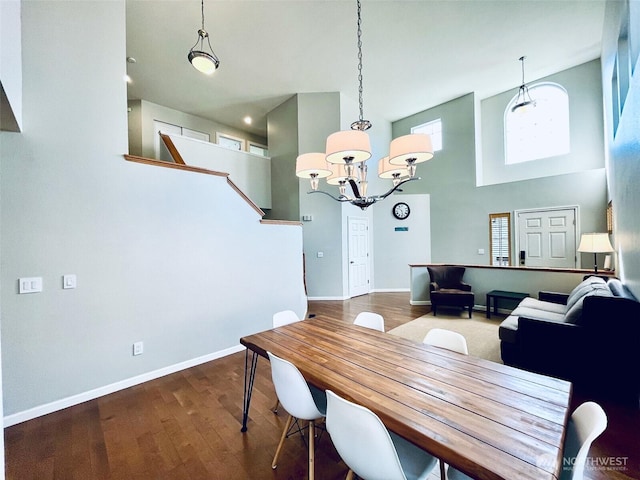 18126 SE 246th St, Covington, WA 98042 - dining space featuring baseboards, wood finished floors, a high ceiling, and a notable chandelier