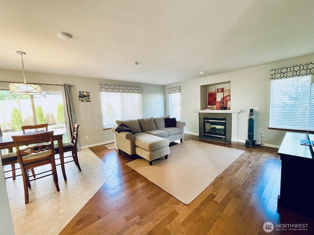 18126 SE 246th St, Covington, WA 98042 - living area featuring baseboards, wood finished floors, and a fireplace