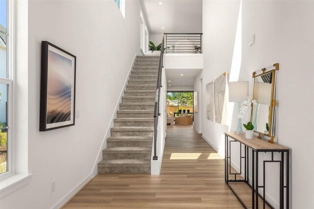 25525LOT1 204th Pl SE, Covington, WA 98042 - stairway with wood finished floors, a high ceiling, and baseboards