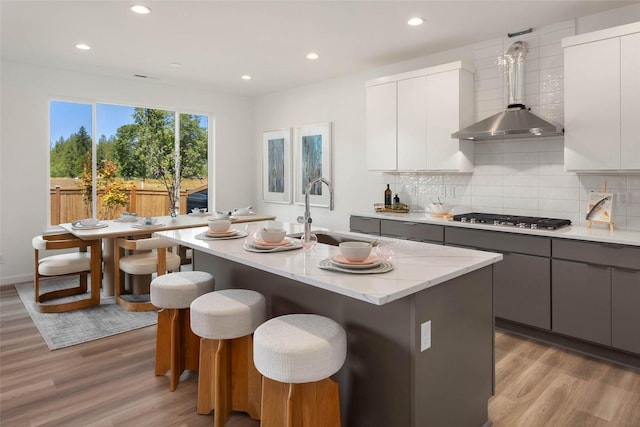 25525LOT1 204th Pl SE, Covington, WA 98042 - kitchen with light wood-type flooring, stainless steel gas cooktop, gray cabinetry, and a sink