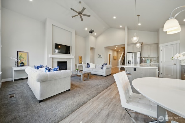308 Chardonnay Ct, Walla Walla, WA 99362 - living room with ceiling fan, a glass covered fireplace, visible vents, and light wood-style flooring