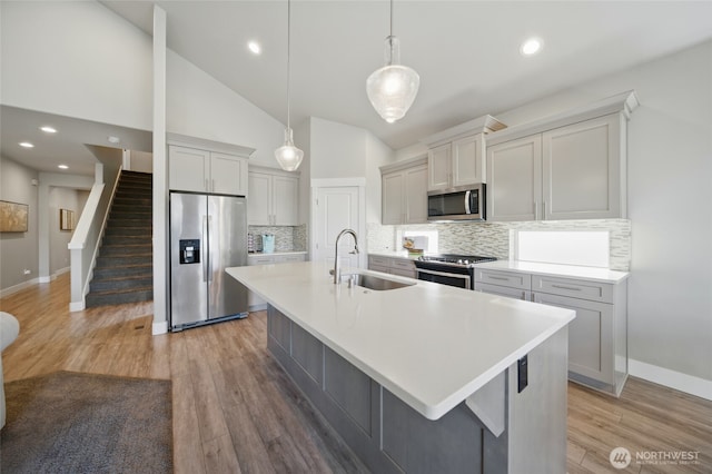 308 Chardonnay Ct, Walla Walla, WA 99362 - kitchen featuring a sink, a center island with sink, baseboards, backsplash, and appliances with stainless steel finishes