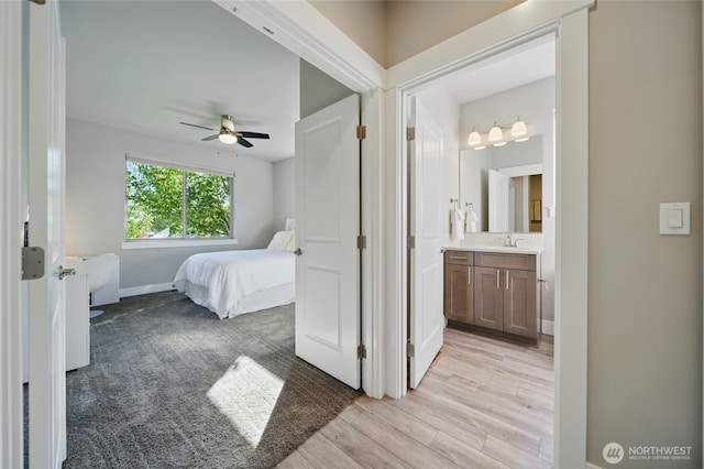308 Chardonnay Ct, Walla Walla, WA 99362 - bedroom featuring a sink, baseboards, light wood-style flooring, ceiling fan, and ensuite bathroom