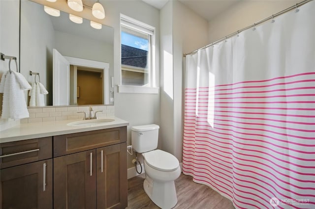 308 Chardonnay Ct, Walla Walla, WA 99362 - bathroom with wood finished floors, decorative backsplash, vanity, toilet, and a shower with shower curtain