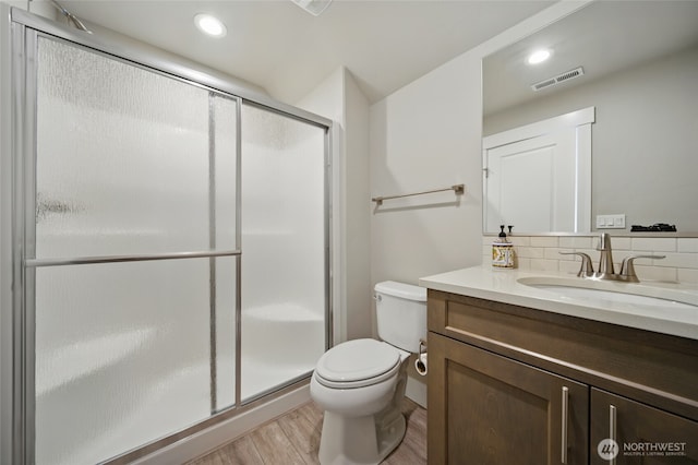 308 Chardonnay Ct, Walla Walla, WA 99362 - bathroom featuring a shower stall, wood finished floors, vanity, toilet, and visible vents