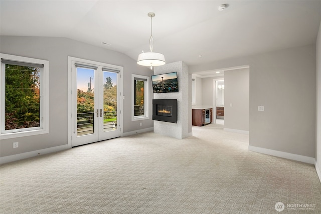 4229 95th Ave NE, Yarrow Point, WA 98004 - unfurnished living room with french doors, vaulted ceiling, baseboards, a large fireplace, and carpet floors