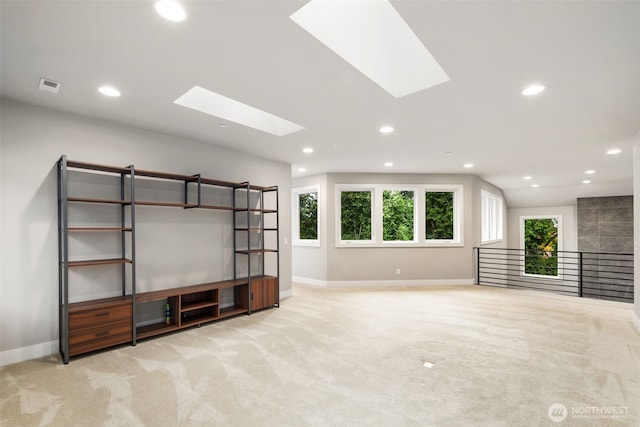 4229 95th Ave NE, Yarrow Point, WA 98004 - unfurnished living room featuring a skylight, baseboards, carpet floors, and recessed lighting