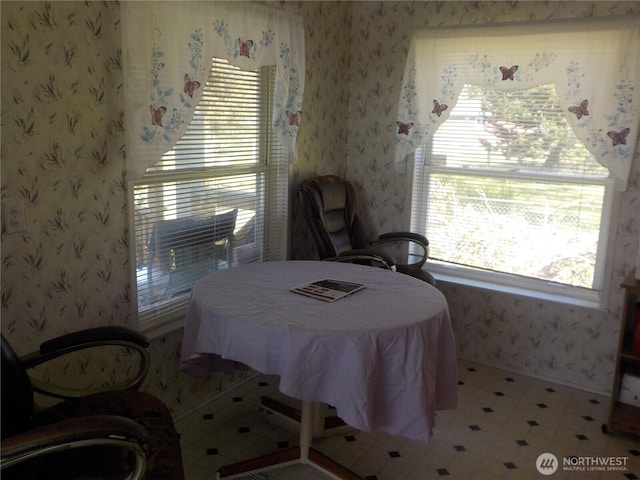 bedroom featuring wallpapered walls and light floors