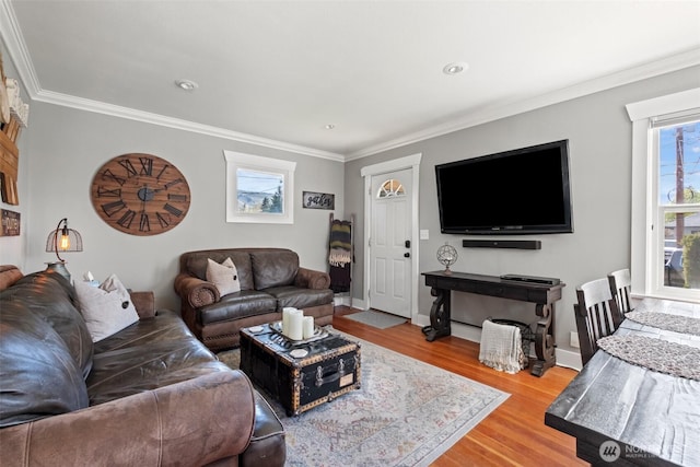 living area with ornamental molding, recessed lighting, and wood finished floors