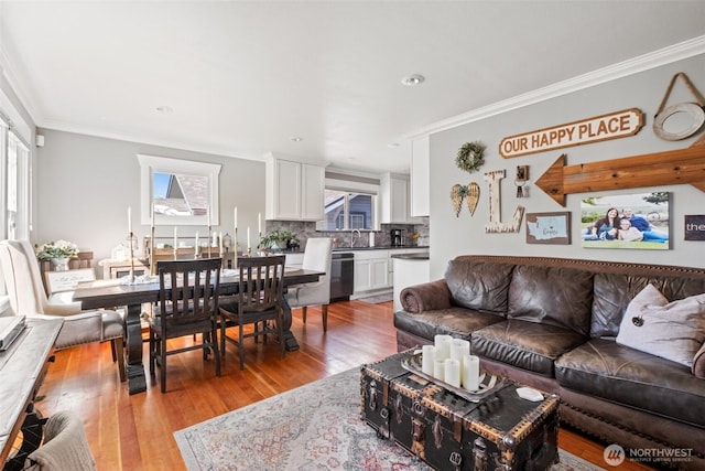 living area with recessed lighting, ornamental molding, and light wood-type flooring