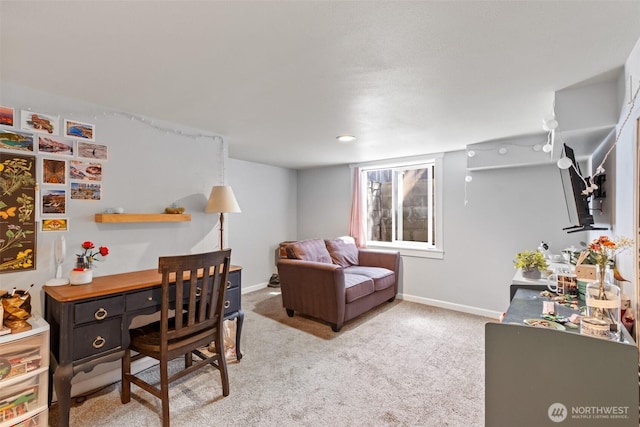 carpeted home office featuring baseboards
