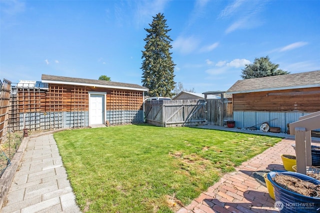 view of yard with a gate and a fenced backyard