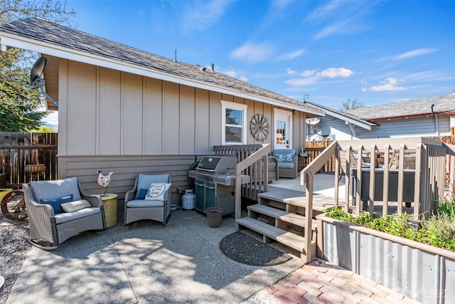 view of front of home featuring a shingled roof, board and batten siding, fence, and a deck