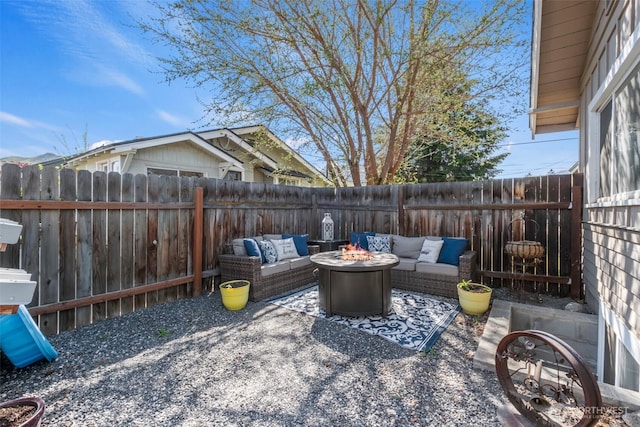 view of patio featuring a fenced backyard and an outdoor living space with a fire pit