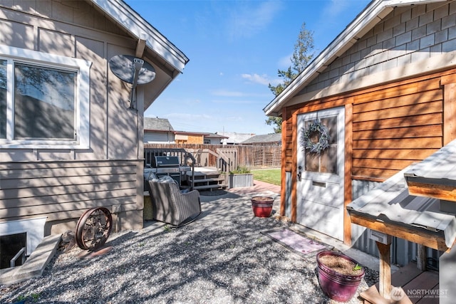 view of patio / terrace featuring fence and a deck