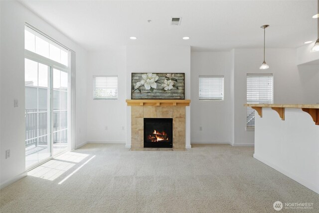 10757 NE Red Wing Way Unit 201, Hillsboro, OR 97006 - unfurnished living room featuring light colored carpet, a tile fireplace, and recessed lighting