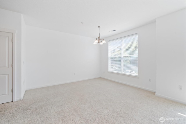 10757 NE Red Wing Way Unit 201, Hillsboro, OR 97006 - spare room featuring a chandelier and carpet