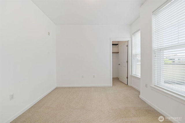10757 NE Red Wing Way Unit 201, Hillsboro, OR 97006 - unfurnished bedroom featuring light colored carpet, a spacious closet, and a closet
