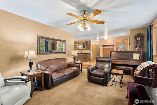 living room featuring light colored carpet and a ceiling fan