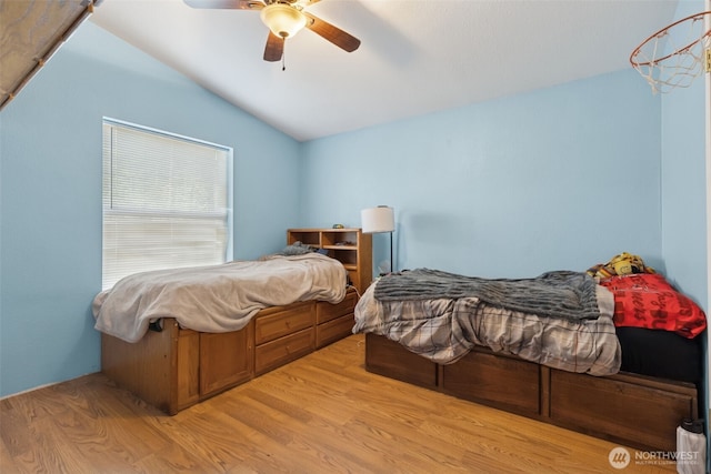 bedroom featuring wood finished floors, a ceiling fan, and lofted ceiling