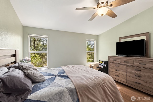 bedroom featuring ceiling fan, wood finished floors, and lofted ceiling