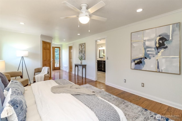 bedroom featuring baseboards, wood finished floors, and recessed lighting