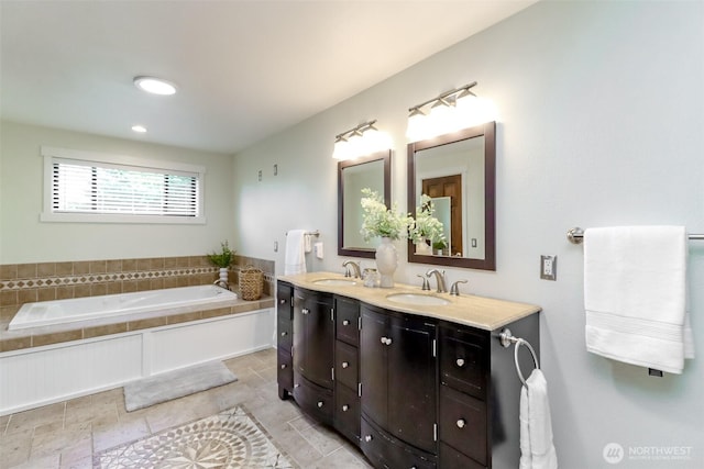 bathroom featuring a garden tub, a sink, and double vanity