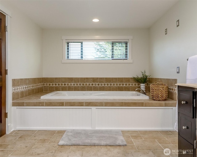 bathroom featuring a garden tub and recessed lighting