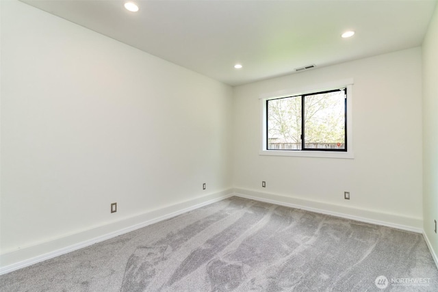 unfurnished room featuring light carpet, baseboards, visible vents, and recessed lighting