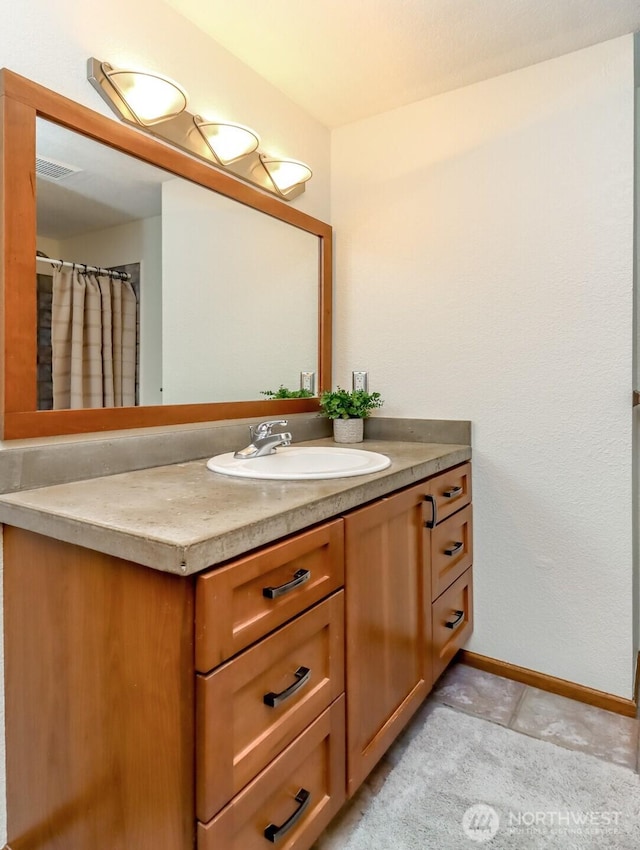 full bath featuring baseboards, visible vents, tile patterned flooring, and vanity