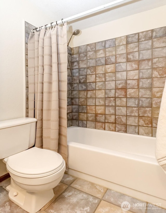 bathroom with shower / bath combo, toilet, and tile patterned floors