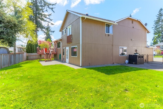 rear view of property featuring stairway, a fenced backyard, a yard, and a patio