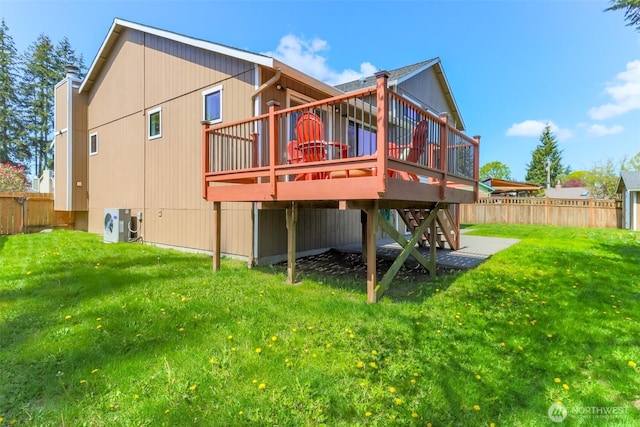 back of house with a lawn, fence, and a deck