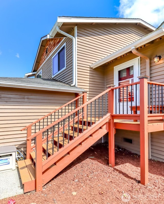 view of side of property with stairway and a deck