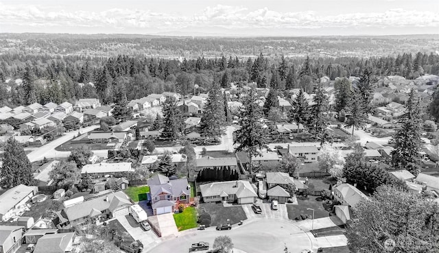 birds eye view of property featuring a residential view and a view of trees
