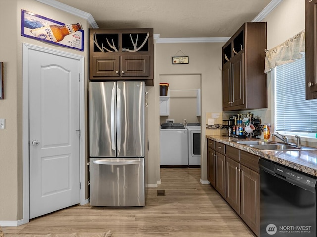 kitchen featuring a sink, dark brown cabinets, freestanding refrigerator, separate washer and dryer, and dishwasher
