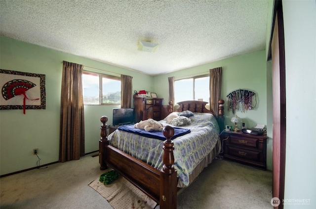 bedroom with carpet flooring and a textured ceiling