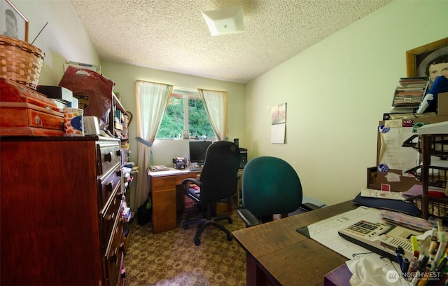 home office with a textured ceiling and dark carpet
