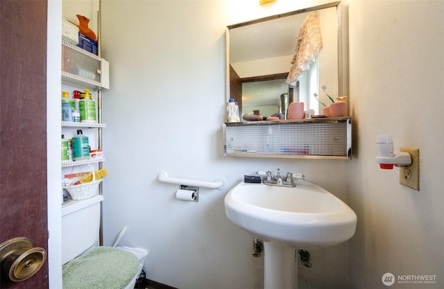 bathroom with toilet and a sink