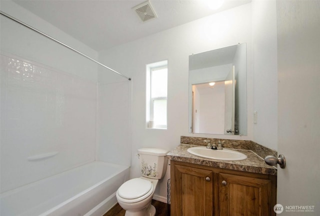bathroom with toilet, vanity, and shower / bath combination