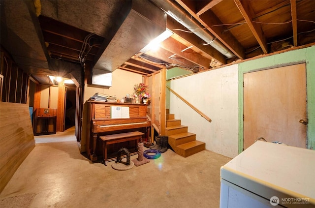 unfinished basement with washer / dryer and stairway