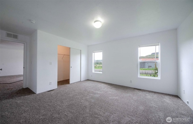 unfurnished bedroom with carpet and a closet