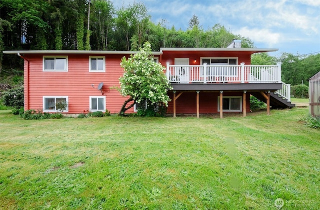 back of house with a deck, a yard, stairway, and a chimney
