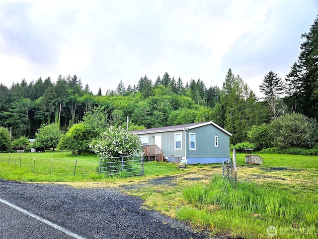 manufactured / mobile home featuring a view of trees