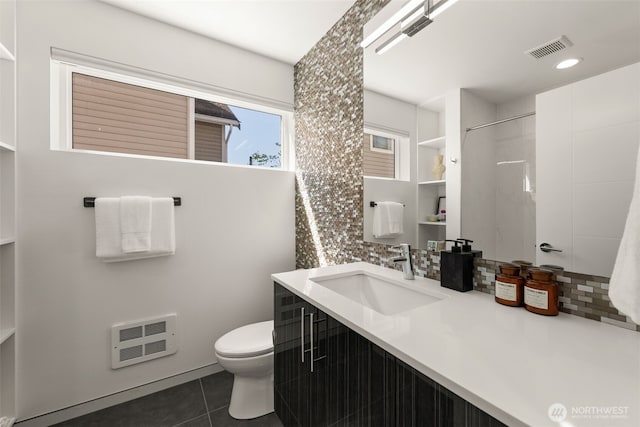 bathroom with tile patterned floors, toilet, tasteful backsplash, visible vents, and heating unit