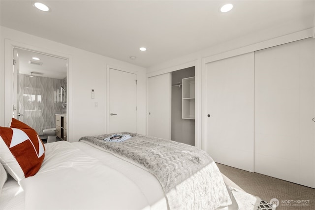 carpeted bedroom featuring recessed lighting and multiple closets