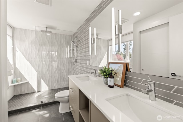 full bath featuring tile patterned floors, walk in shower, a sink, and double vanity