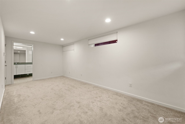 unfurnished bedroom with light colored carpet, baseboards, and recessed lighting